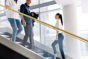 Group of businessman walking and taking stairs in an office building